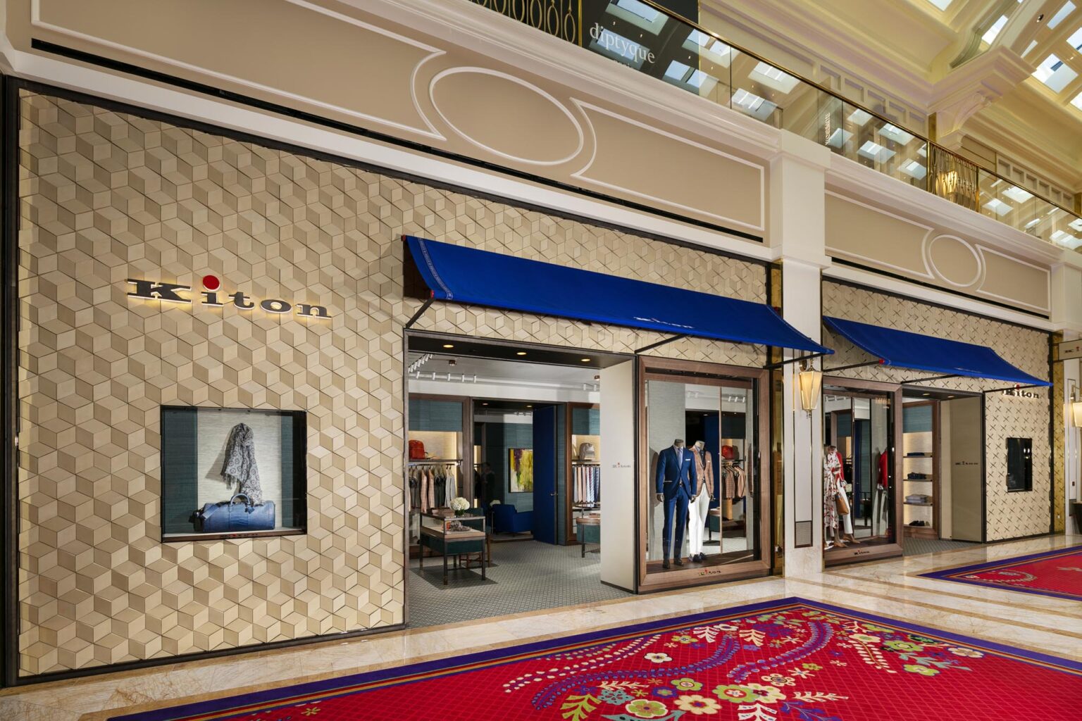 Kiton apparel luxury store facade with 3d shape tiles and blue canopy
